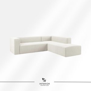 Minimalist modular sectional sofa in soft off-white fabric with clean lines and a low, blocky silhouette.