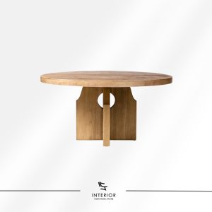 Round solid wood dining table with sculptural central base and natural wood finish