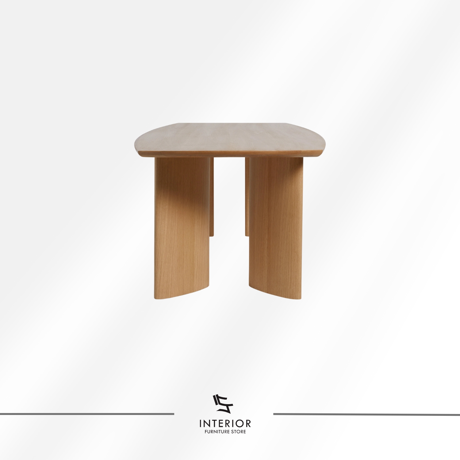 Modern solid wood dining table with elongated tabletop and sculptural wooden legs in natural finish
