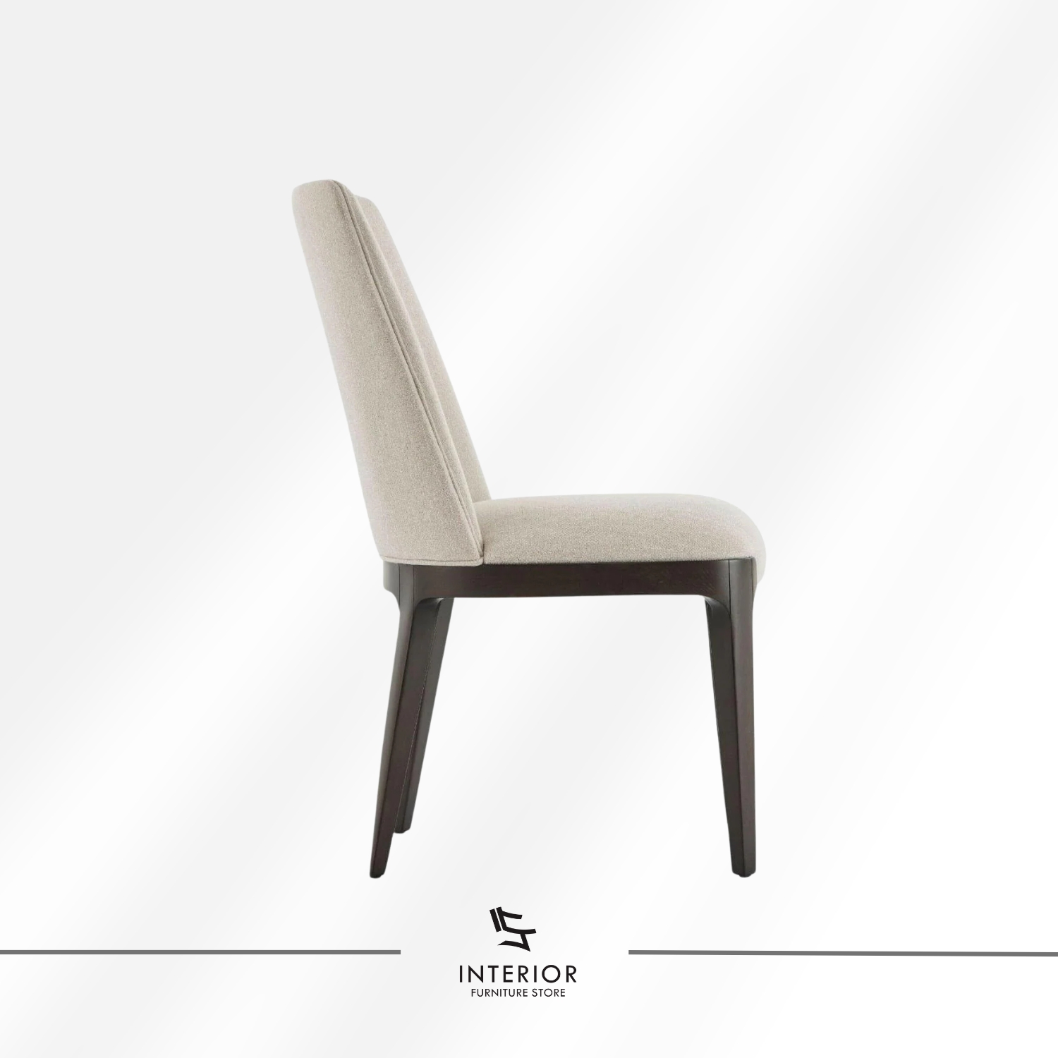 Upholstered dining chair with a curved backrest, beige fabric finish, and dark wooden legs.