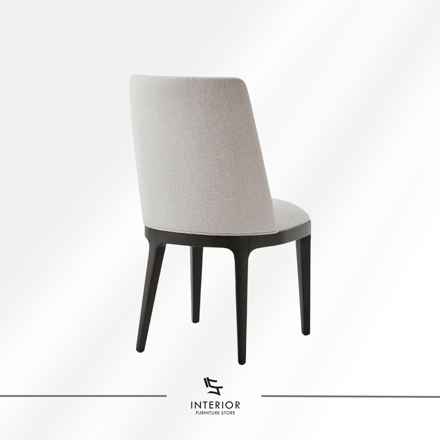 Upholstered dining chair with a curved backrest, beige fabric finish, and dark wooden legs.