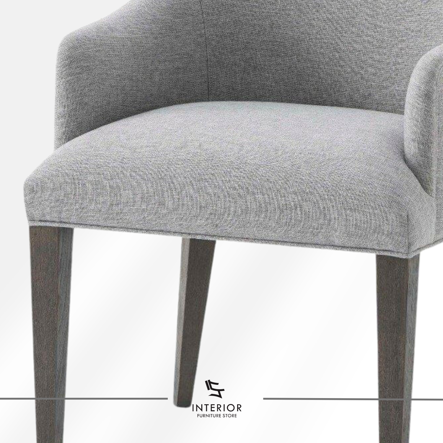 Upholstered dining chair with a light grey fabric finish, curved armrests, and dark wooden legs.