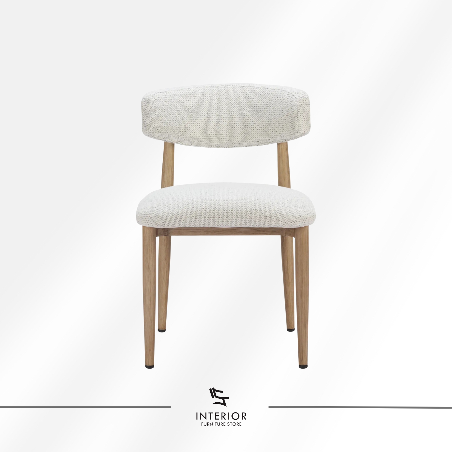 Upholstered dining chair with a rounded fabric backrest and seat, supported by natural wooden legs.