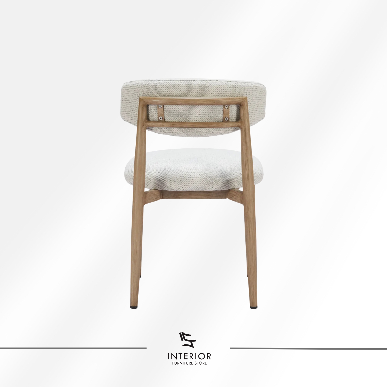 Upholstered dining chair with a rounded fabric backrest and seat, supported by natural wooden legs.