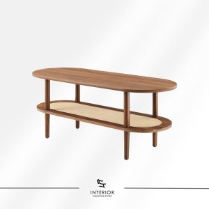 Oval wooden coffee table with a rounded top, cylindrical legs, and a lower shelf featuring woven rattan detail.