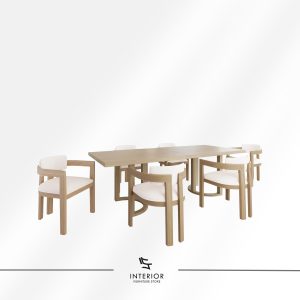 Light wood dining table set featuring six upholstered armchairs with curved backrests, soft neutral cushions, and a spacious rectangular tabletop designed for comfortable shared meals.