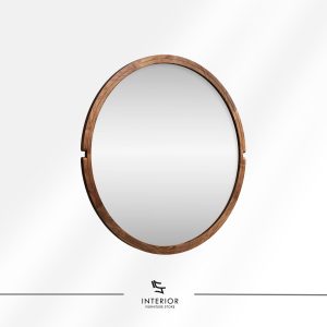Round wall mirror with a solid wood frame and subtle carved side accents.