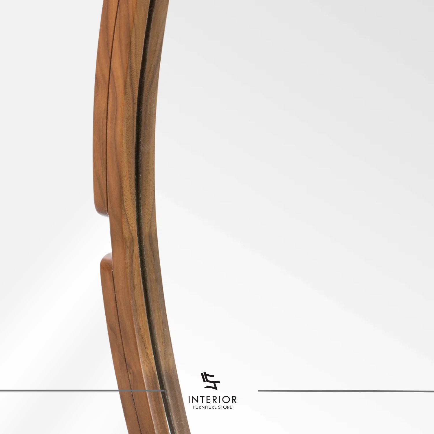 Round wall mirror with a solid wood frame and subtle carved side accents.