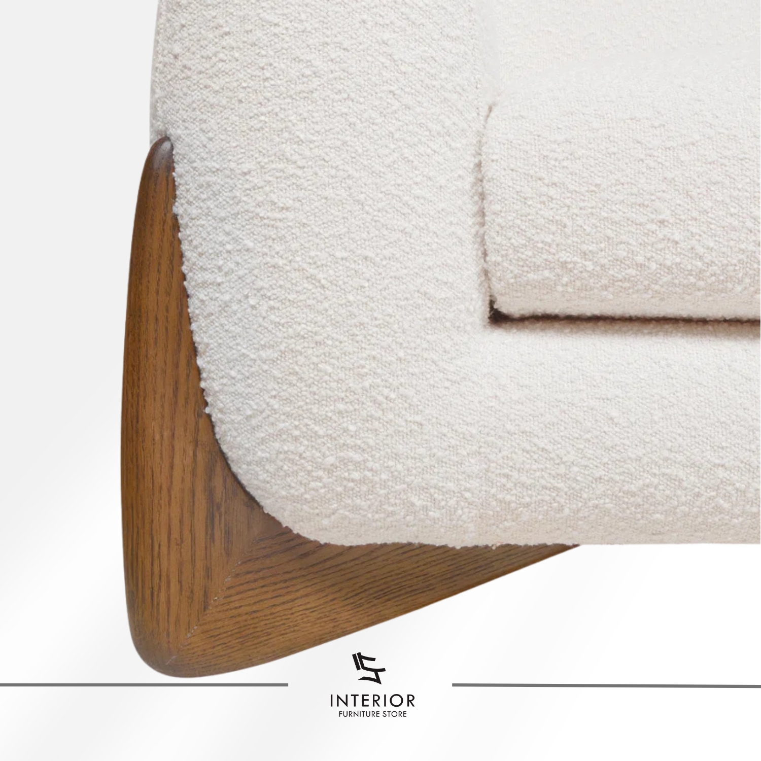 Curved modern sofa with textured cream upholstery and sculpted wooden side supports.