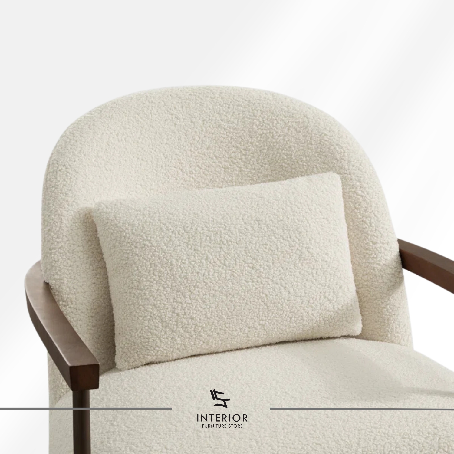 Modern armchair with textured cream upholstery, curved backrest, and solid wooden armrests and frame.