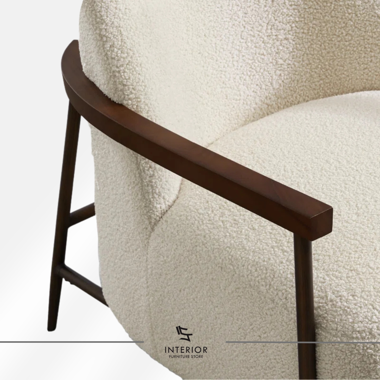 Modern armchair with textured cream upholstery, curved backrest, and solid wooden armrests and frame.