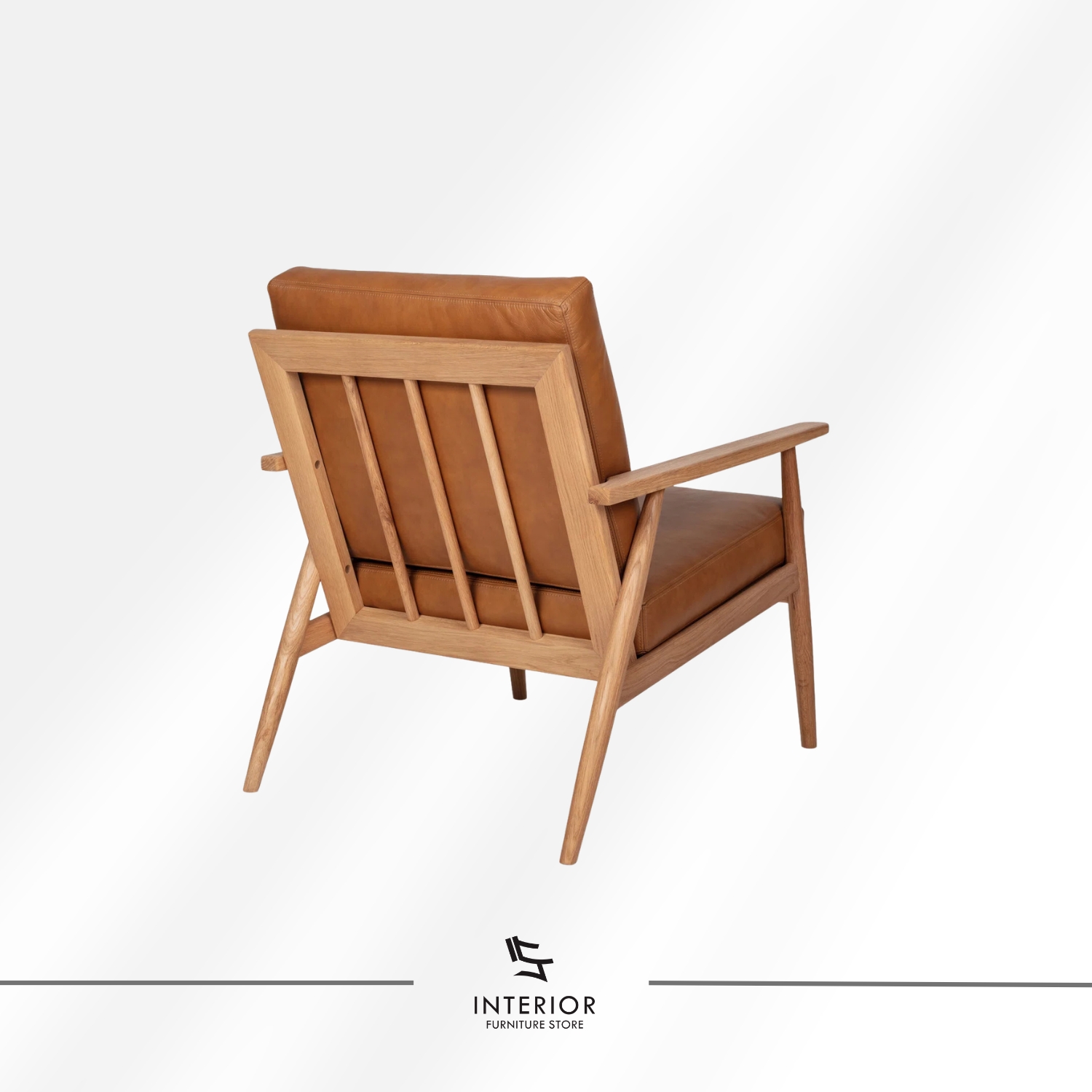 Solid wood armchair with angled frame and brown leather cushion, minimalist modern design