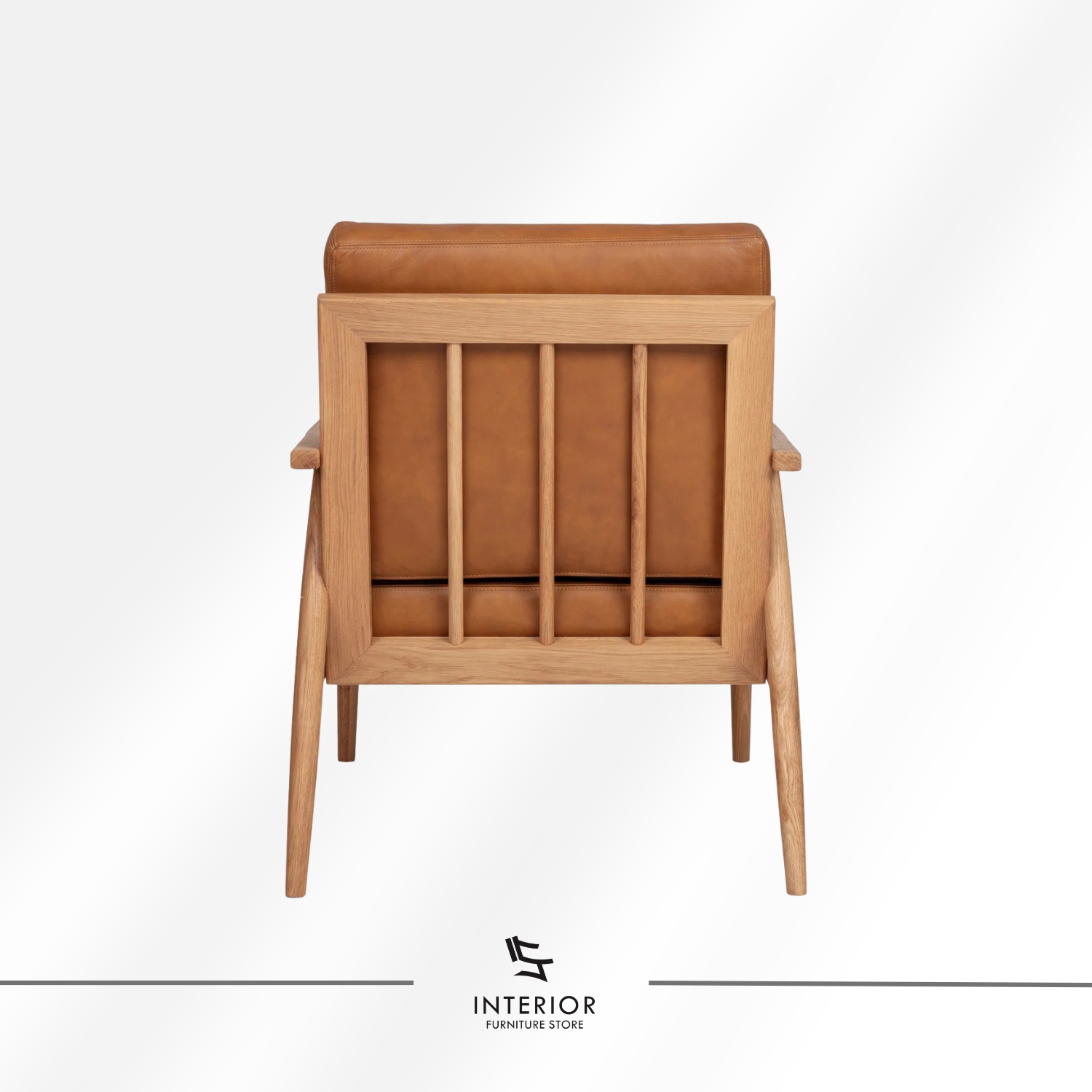Solid wood armchair with angled frame and brown leather cushion, minimalist modern design