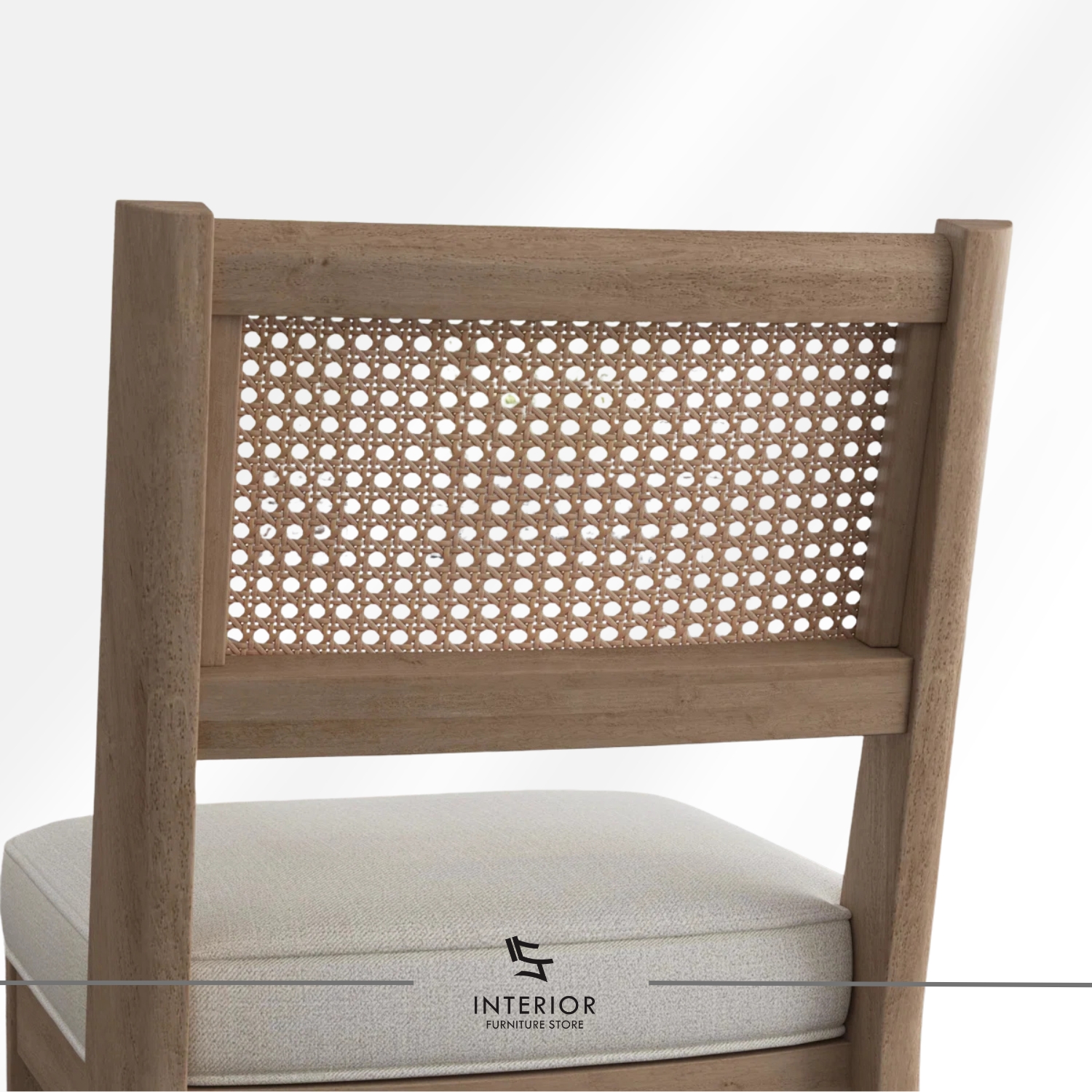 Wooden dining chair with a woven cane backrest and a cushioned upholstered seat.