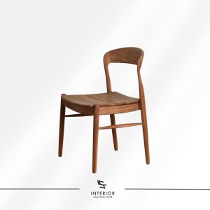 Solid wood dining chair with a contoured seat, curved backrest, and warm natural wood finish.