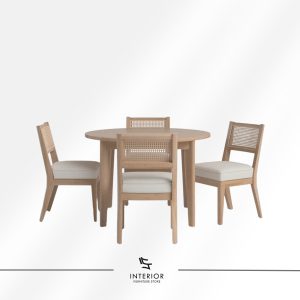 Round wooden dining table set with four rattan-back chairs and cushioned seats