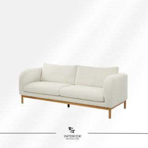 Modern sofa with soft cream upholstery, rounded armrests, and a light wood base with tapered legs.
