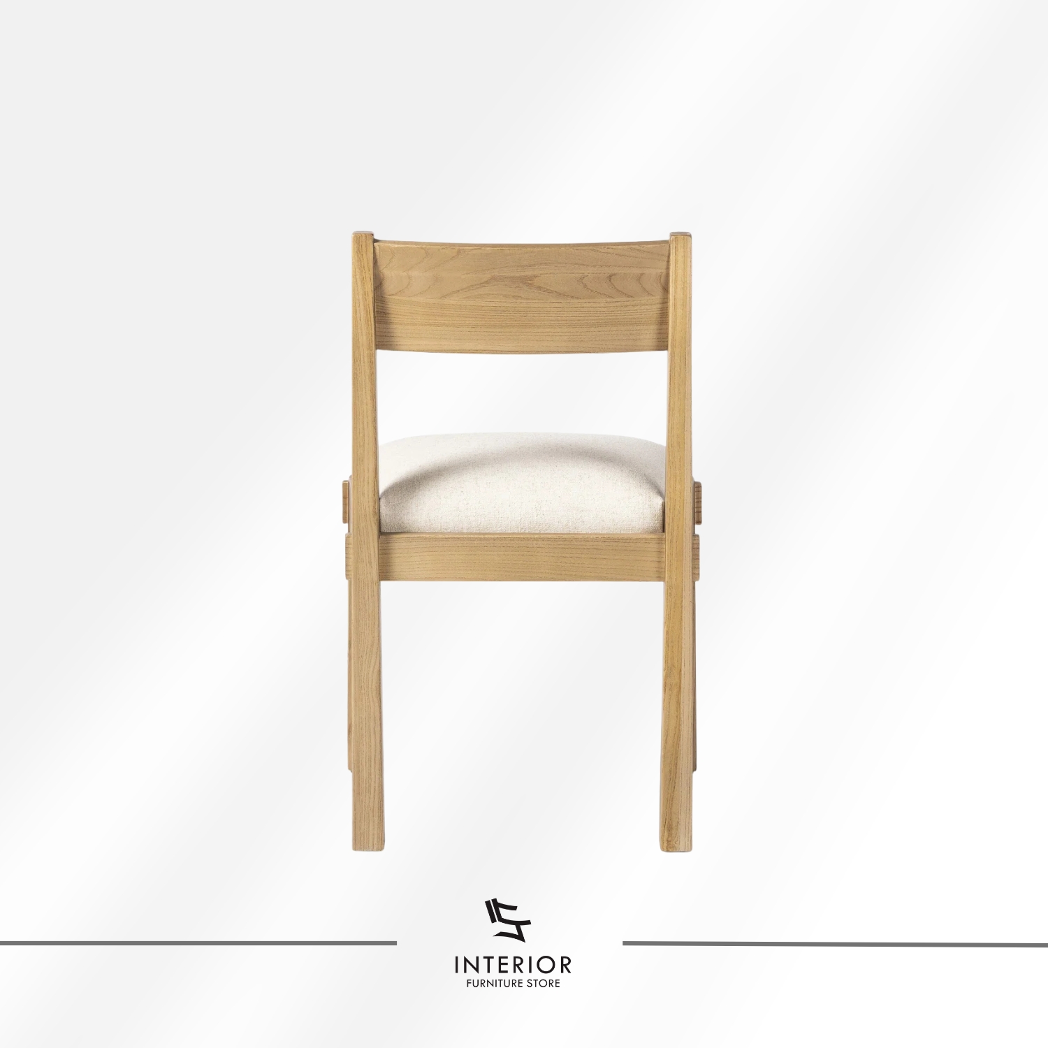 Solid wood dining chair with a cushioned upholstered seat and clean-lined silhouette.