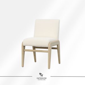 Upholstered dining chair with a solid wood frame, fully wrapped in soft textured fabric.