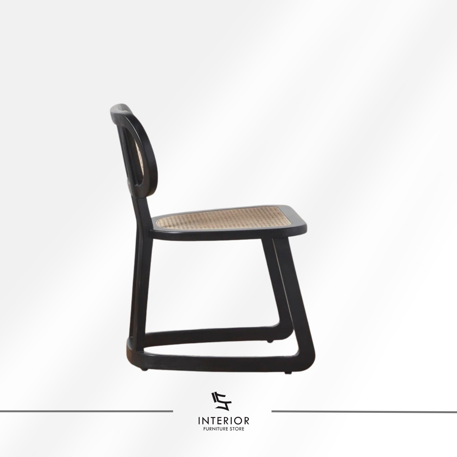 Black wooden dining chair with woven cane seat and backrest.