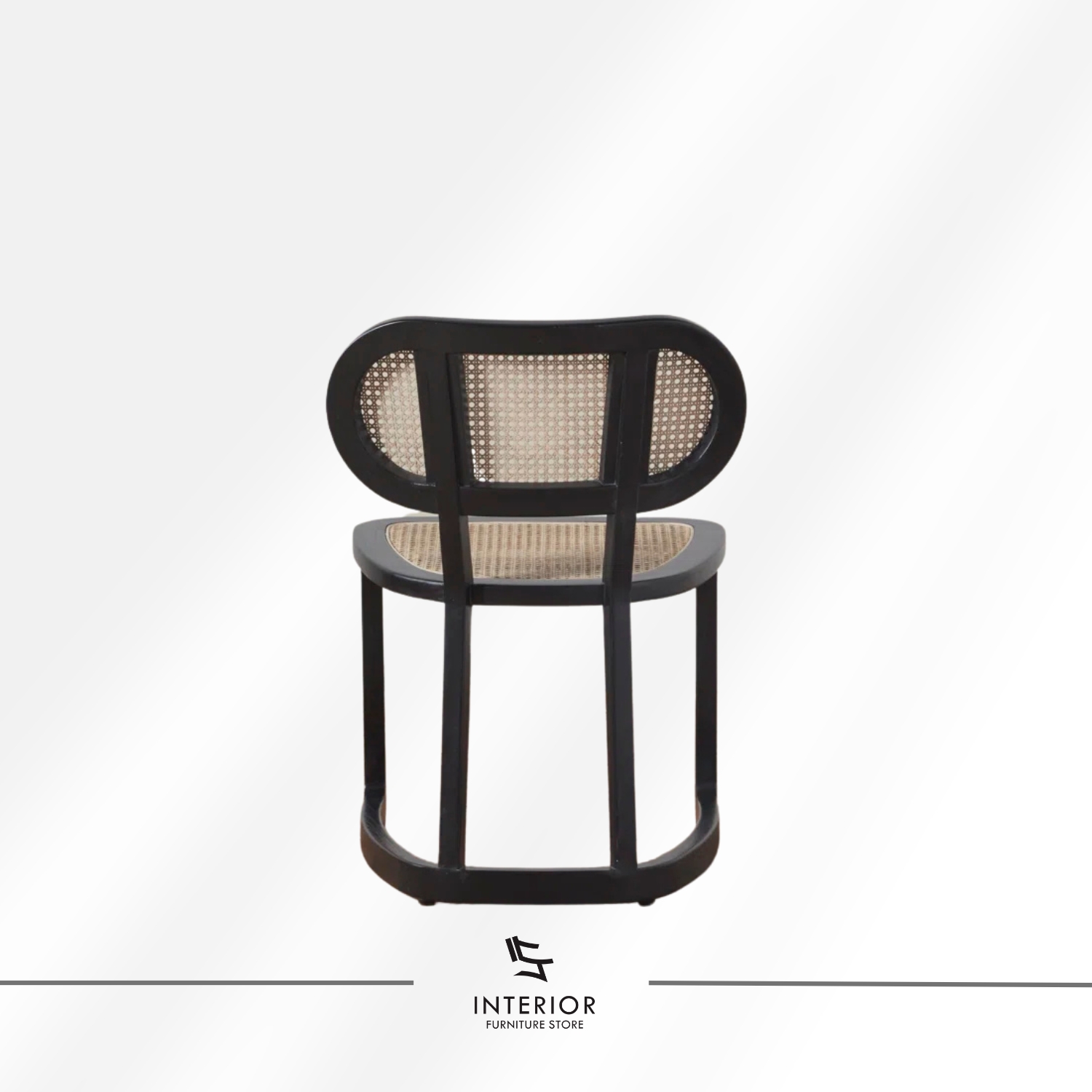 Black wooden dining chair with woven cane seat and backrest.
