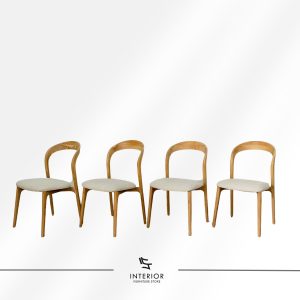 Modern wooden dining chair with a curved backrest, upholstered seat, and tapered legs.