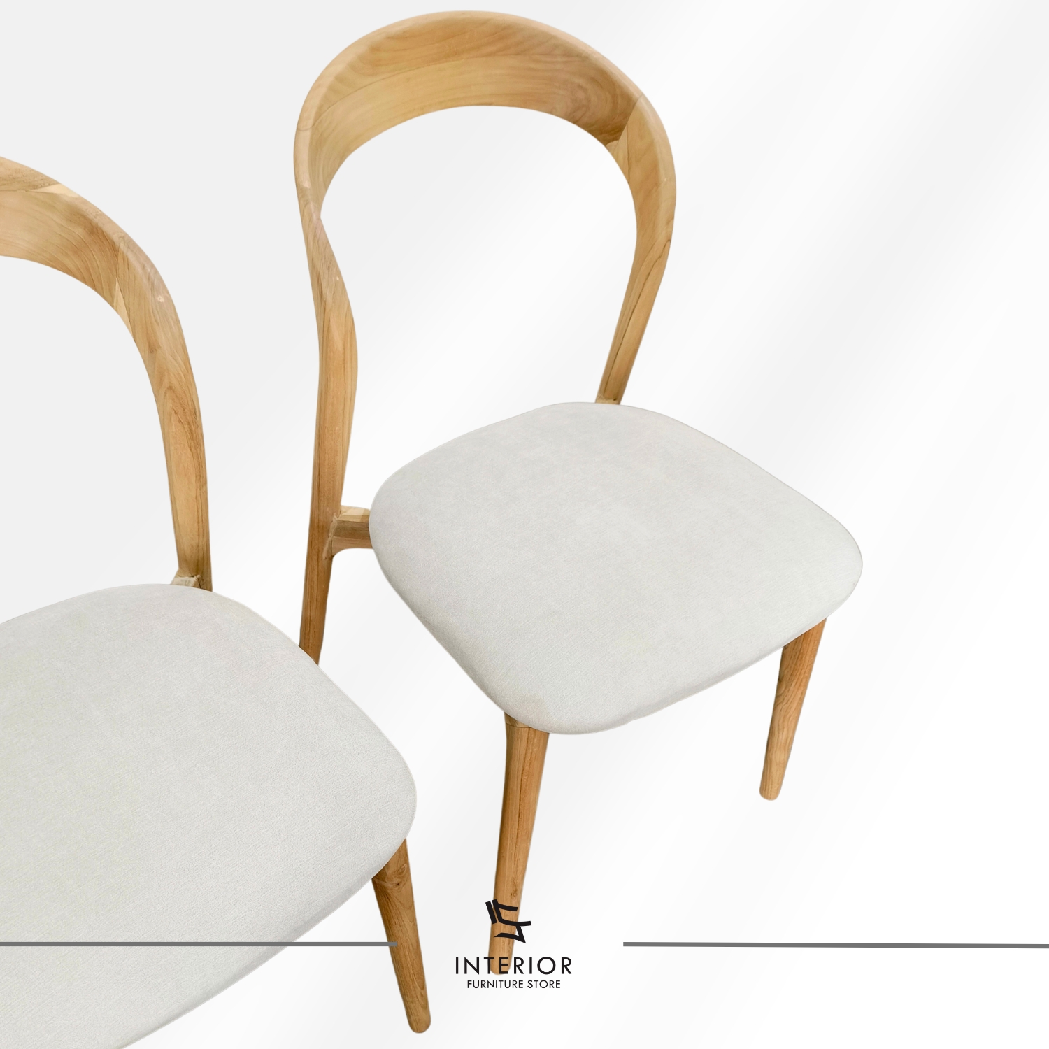 Modern wooden dining chair with a curved backrest, upholstered seat, and tapered legs.