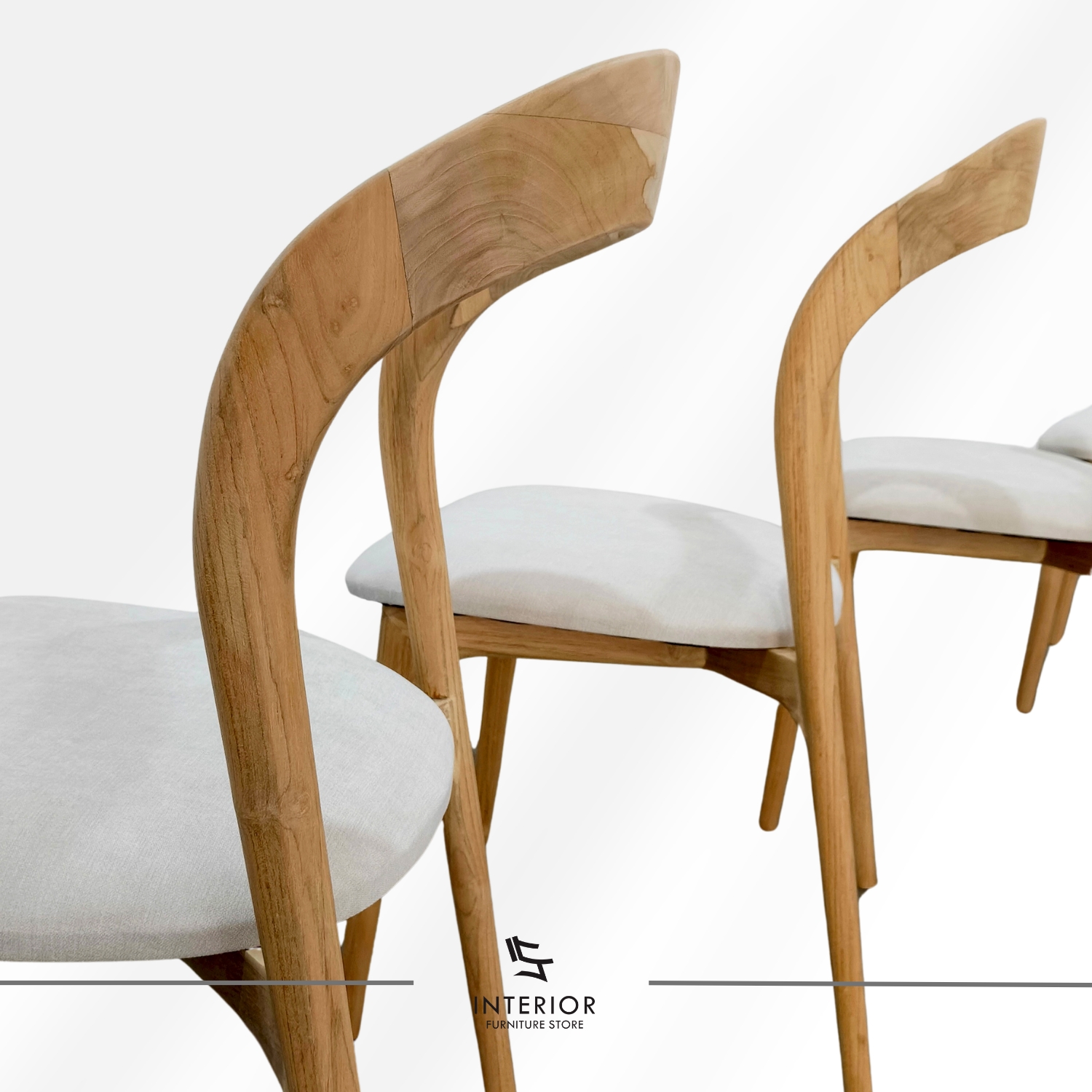 Modern wooden dining chair with a curved backrest, upholstered seat, and tapered legs.
