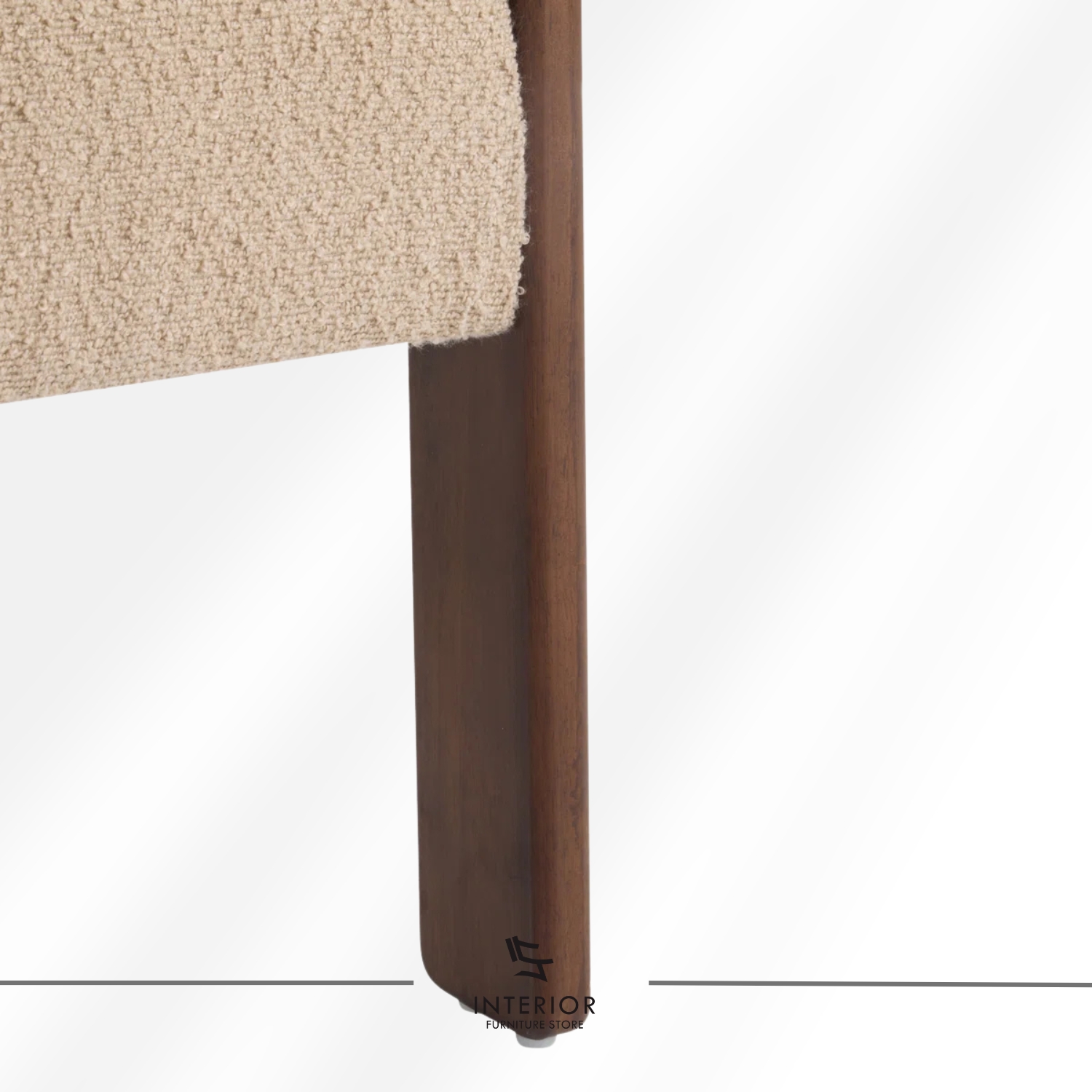 A modern armchair with a curved upholstered backrest and seat in soft beige fabric, supported by a dark wooden frame with clean lines.