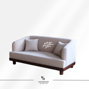 Gayaka upholstered lounge sofa with curved arms, soft cushions, and wooden base